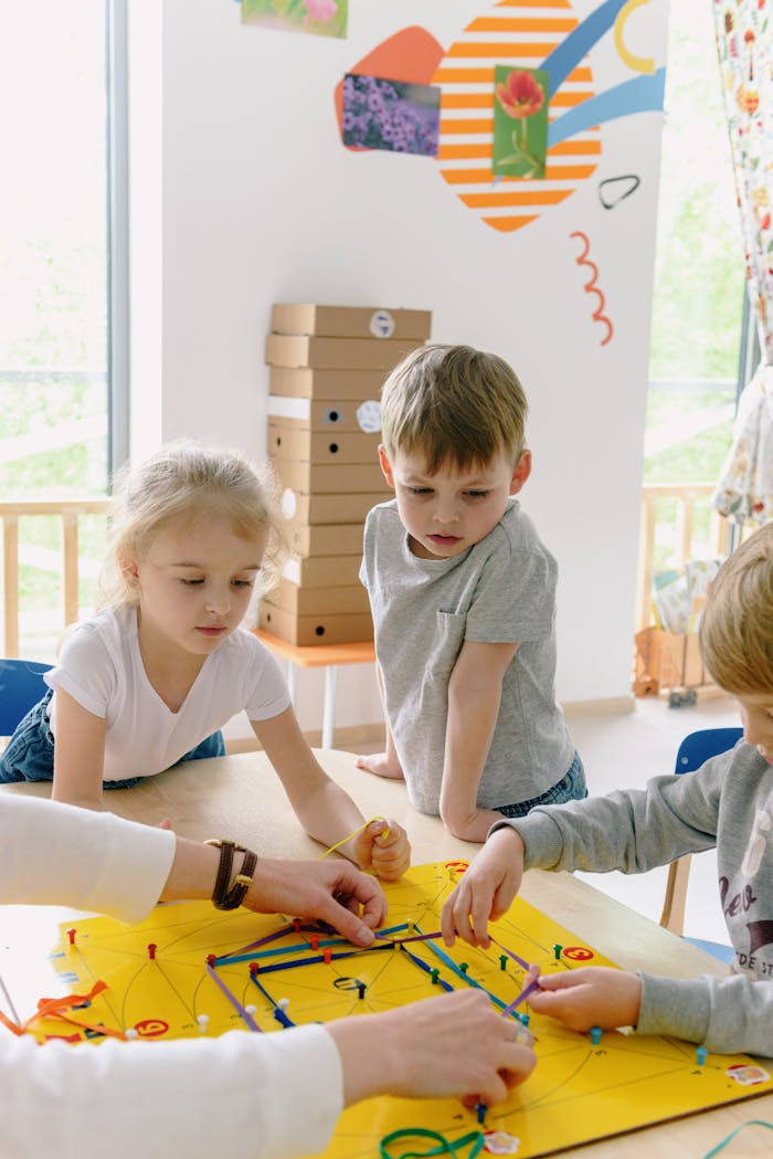 services-02 Kids collaborating on a colorful project in a bright kindergarten classroom.